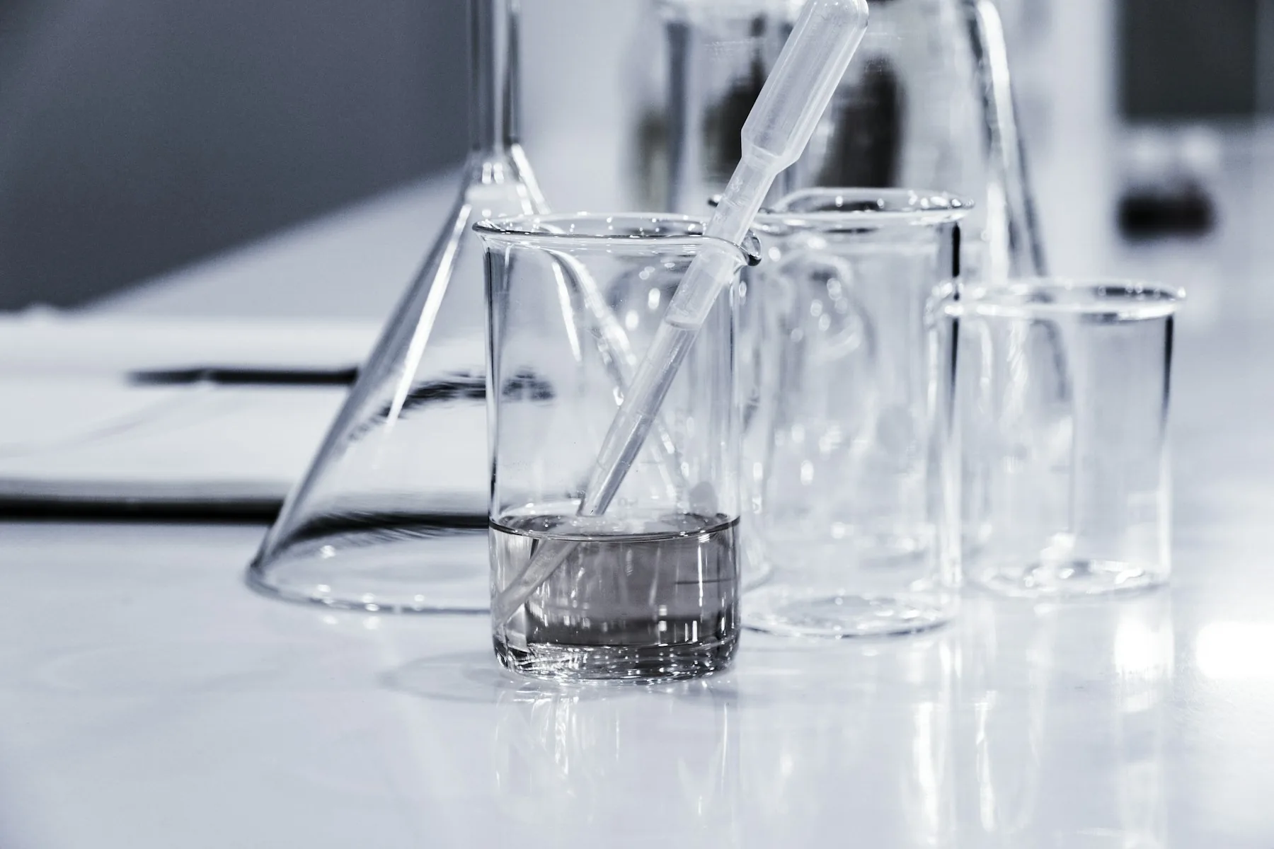 Glass laboratory vessels in a bright research environment